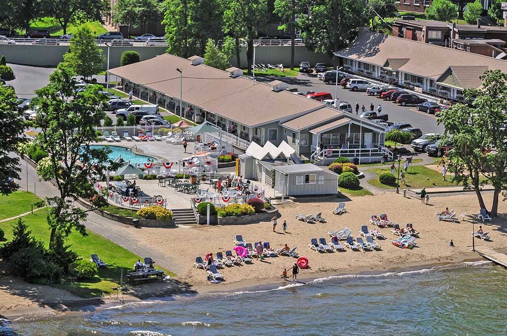 overhead view of the motel property with sandy beach and pool