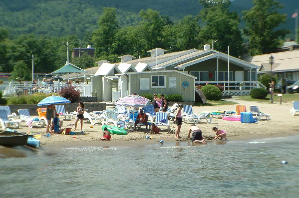 Beach with people chatting and kids digging in sand